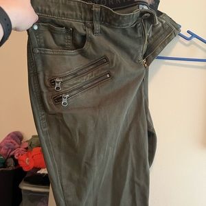 Olive green skinny jeans with sassy zipper detail